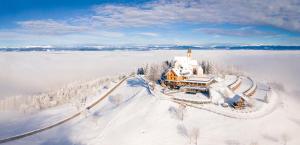 an aerial view of a house in the snow at Gipfelhaus Magdalensberg in Sankt Veit an der Glan