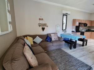 a living room with a couch and a table at Cabana Del Mar 69 in Amanzimtoti