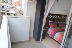 a small bedroom with a bed and a window at Balcarce city in San Miguel de Tucumán