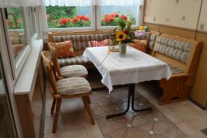 Una habitación con una mesa con un jarrón de flores. en Ferienwohnung Bradsch, en Ilmenau