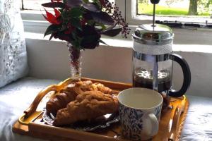 a tray with a plate of food and a cup of coffee at Spacious Durham City Centre Riverside Apartment in Durham