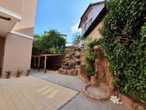 a stone wall with plants on it next to a building at Summer Apart Janet in Obzor