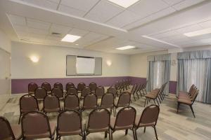 a room with rows of chairs and a projection screen at La Quinta by Wyndham Mobile - Daphne in Daphne +37 photos