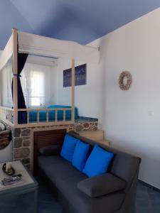 a living room with a couch with blue pillows at Villa Anna in Skaliá