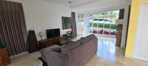 a living room with a couch and a television at Villa Marbelice in Bandung