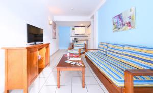 a living room with a couch and a table at Marianela Apartment in Puerto Rico de Gran Canaria