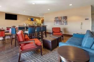a living room with a couch and chairs and a bar at Comfort Inn Shelbyville North in Shelbyville
