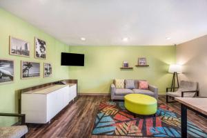 a living room with a couch and a tv at WoodSpring Suites Bradenton in Bradenton