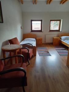 A bed or beds in a room at Vadászkürt Vendégfogadó