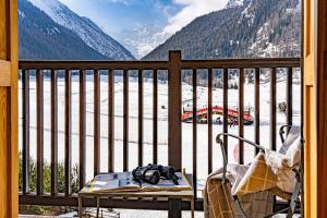 a camera sitting on a bench on a balcony at Hotel Sant'Orso - Mountain Lodge & Spa in Cogne
