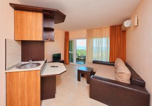 a kitchen and living room with a couch and a sink at Guest House California in Pomorie