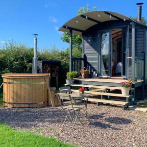 a blue tiny house with a table and a bench at Westfield House Farm in Rothbury +87 photos