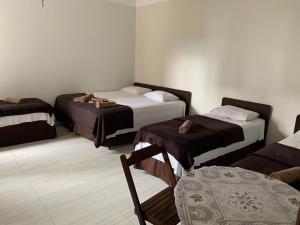 Een bed of bedden in een kamer bij Hotel da Rainha Cachoeira Paulista
