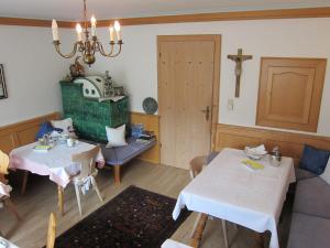 a dining room with two tables and a cross on the wall at Gästehaus Valentina in Mayrhofen