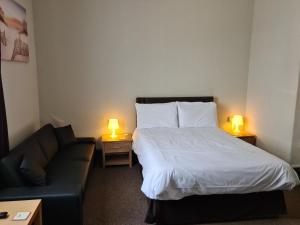 a hotel room with a bed and a couch at Royal Albion Walton in Walton-on-the-Naze