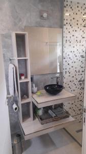 a bathroom with a sink and a mirror at dolce casa 2 in San Clemente del Tuyú