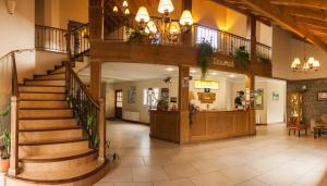 a lobby with a staircase in a building at Patagonia Hostel in El Chalten