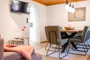 a living room with a dining room table and chairs at Apartment Ferienhaus Seidlgut in Wagrain