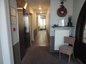 a hallway with a chair and a radiator in a room at Hotel Het Zoete Water in Hamme