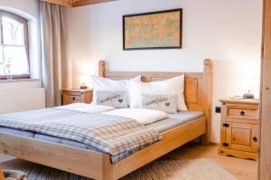 a bedroom with a wooden bed with white pillows at Apartment Ferienhaus Seidlgut in Wagrain