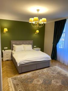 a bedroom with a bed and a green wall at Casa Stef in Sibiu