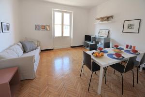 ein Wohnzimmer mit einem Tisch und einem Sofa in der Unterkunft La Casa della Fiore in Camogli
