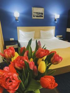 a bouquet of flowers sits on a table in a hotel room at Antic in Moscow