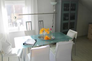 a dining room table with white chairs and a blue at Haus Sonnenschein in Lam