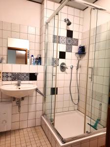 a bathroom with a shower and a sink at Easy Stay Residence in Stuttgart
