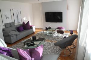 a living room with a couch and a tv at Haus Sonnenblick in Lam