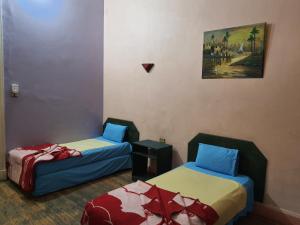 Postel nebo postele na pokoji v ubytování African House Hostel