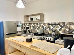 a kitchen with a stove and a refrigerator at Sucre Center in Sucre