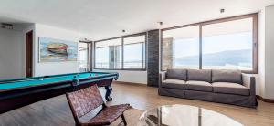 a living room with a pool table and a couch at Departamento Pucón - Salida directa al Lago Villarrica in Pucón