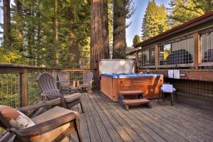 a deck with a pool table and chairs on a house at Lily Pad - Hot Tub! Private Dock! BBQ! Game Room! Walk to Town!! Fast WiFi!! Dog Friendly! in Guerneville