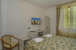 Ένα ή περισσότερα κρεβάτια σε δωμάτιο στο Hotel Vittoria