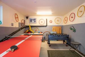 a room with ping pong tables and clocks on the wall at Vino Velo Retreat! Redwoods! Hot Tub!! Fire Table!! BBQ!! Game Room!! Fast WiFi!! Dog Friendly!! in Guerneville