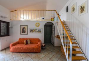 a living room with a staircase and a couch at Basilicata Host To Host - BORGO SAN BASILIO 2 in Marina di Pisticci +39 photos