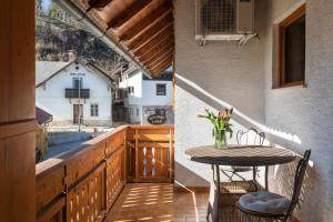 a balcony with a table and a view of a house at Holiday Lake in Bled