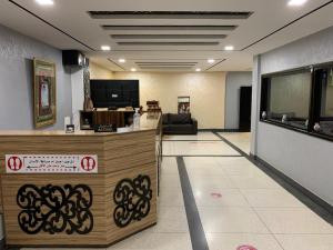 a lobby with a reception desk in a building at Hôtel Sable d'Or in Tan-Tan