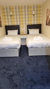 two beds sitting next to each other in a room at The Aston Inn in Birmingham