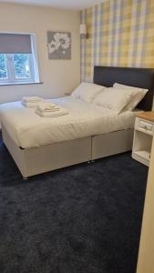 a large bed in a bedroom with a window at The Aston Inn in Birmingham