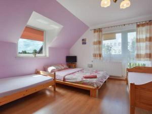 a bedroom with two beds and a window at Agroturystyka Nad Bugiem Szuminka in Szuminka