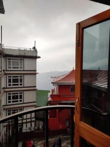 a view of a building from a balcony at Hotel The Narayani Continental in Gangtok