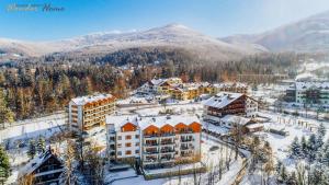 an aerial view of a resort in the snow at Wonder Home - Apartamenty z balkonami, blisko centrum Karpacza, stoku i aquaparku in Karpacz