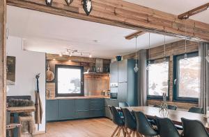 a kitchen and dining room with a table and chairs at Chalet on the Rood Zell am See Kaprun in Piesendorf