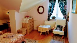 a bedroom with a bed and a table and a window at Dom Gościnny Wisteria in Andrychów +67 photos