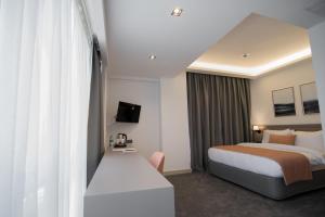 A bed or beds in a room at Dovv Hotel Busıness