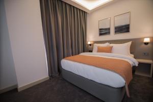 A bed or beds in a room at Dovv Hotel Busıness