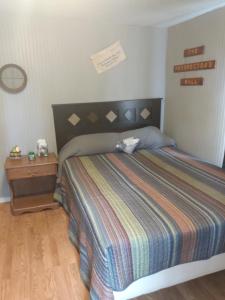 a bedroom with a large bed and a wooden floor at The Diamond Hideaway in Murfreesboro
