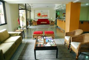 a living room with couches and a coffee table at Hotel Riviera in Sao Jose do Rio Preto
